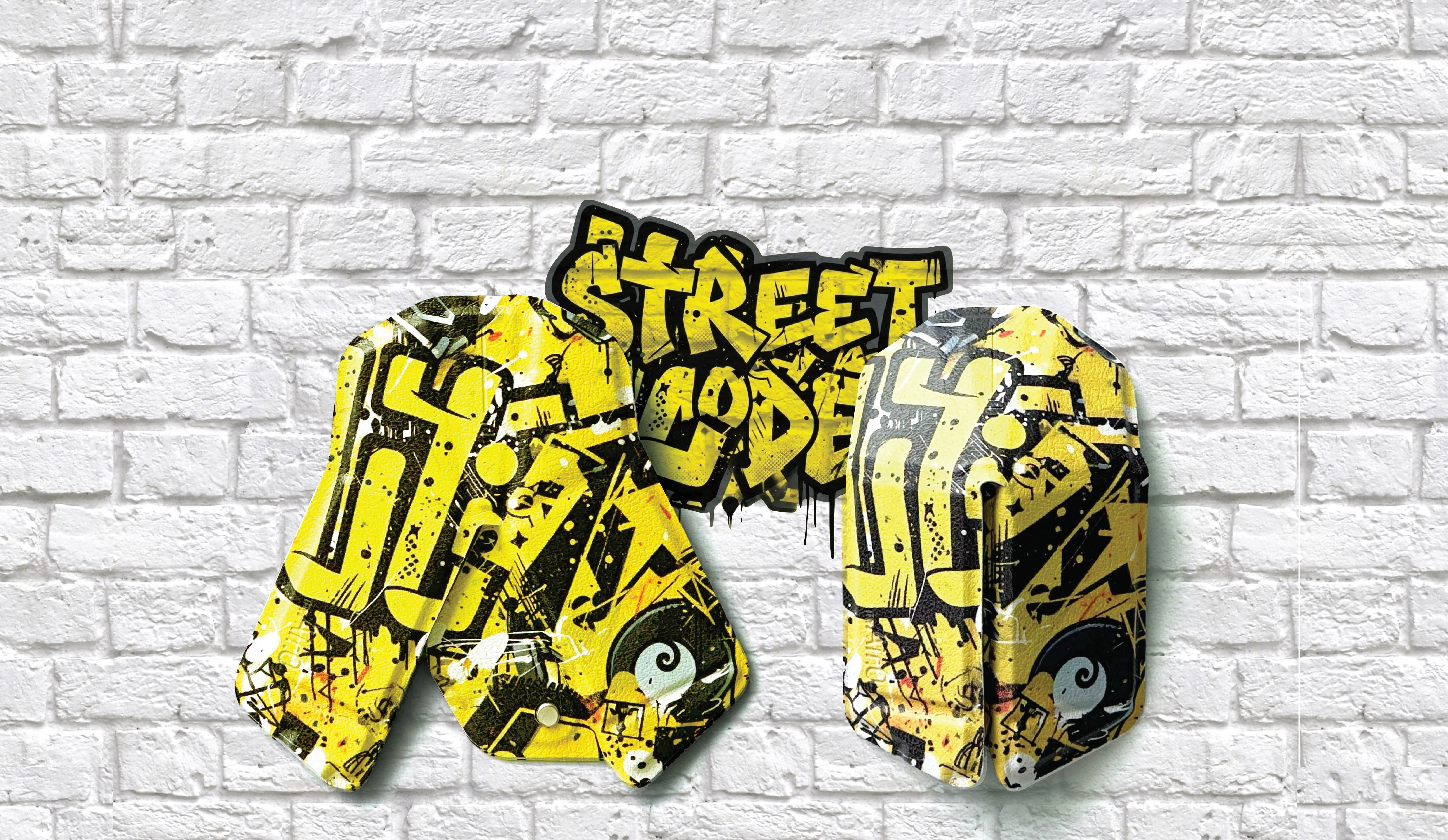 Yellow and black 'Street Code' shoes on a white brick wall background